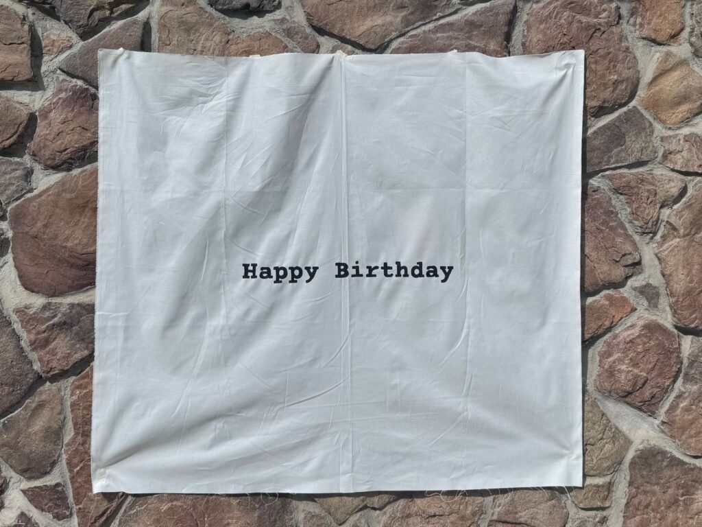 finished product of the hand-painted linen sign